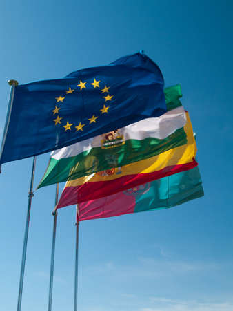 European Union, Spain, Andalusia and Granada banners under blue skiesの写真素材