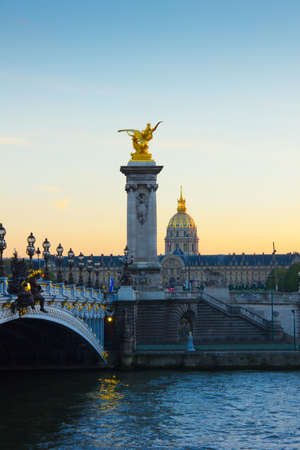 Alexander the Third bridge and Seine with golden Invalides dome at sunset in Parisのeditorial素材