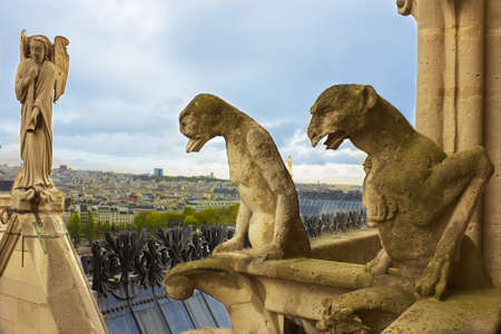 Famous figures of gargoyles and angel of Notre Dame (built in 1240) over Paris aerialの写真素材