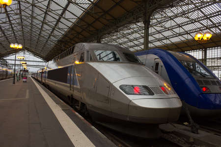 High-speed modern commuter train at classic station