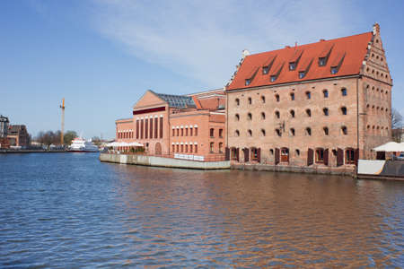 Old town houses and street cafes over Motlawa river in Gdansk, Poland
