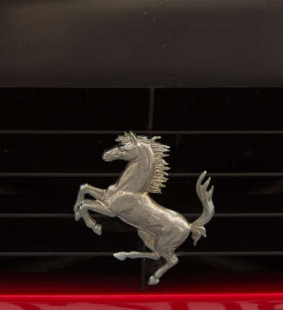 PUERTO DE LA CRUZ - JULY 14: The Cavallino Rampante, symbol of Ferrari on red luxury car at opening of Exposicion de vehiculos antiguos y clasicos, on July 14, 2013 in London. Ferrari has used the Cavallino Rampante since 1929.のeditorial素材
