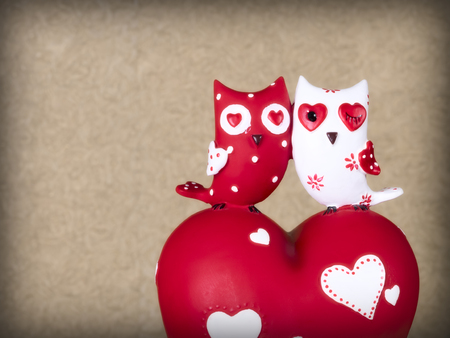Ceramic owls sitting on the heartの写真素材