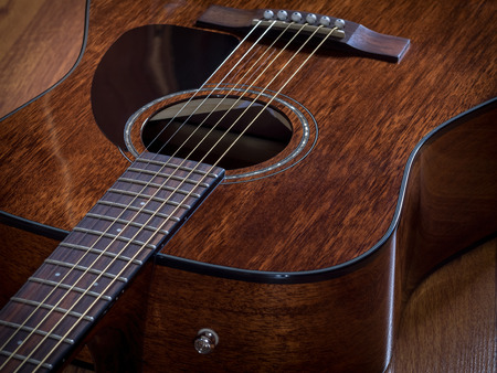 Acoustic guitar lying on the wooden floorの写真素材