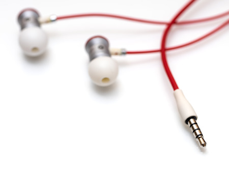 Modern portable audio earphones on a white backgroundの写真素材