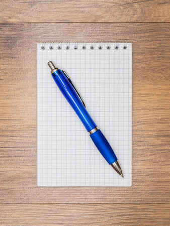 Notebook and pen lying on the tableの写真素材