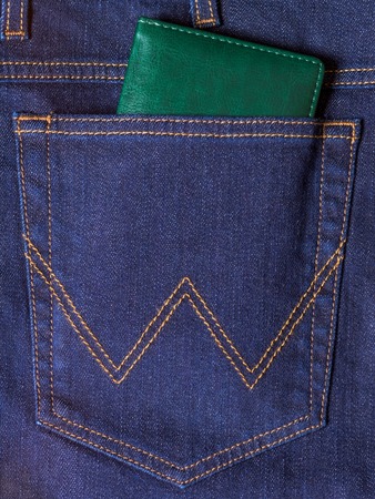 Green notebook in the back pocket of jeansの写真素材