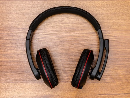 Unbranded headphones lying on the wooden tableの写真素材