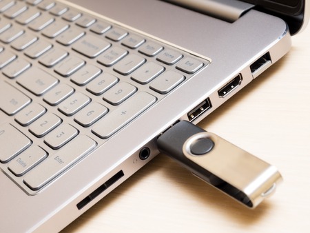 View of laptop keyboard and USB flash drive