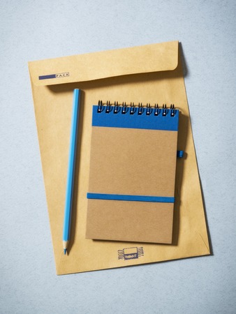 Notebook, pencil and envelope on the table. Top viewの写真素材