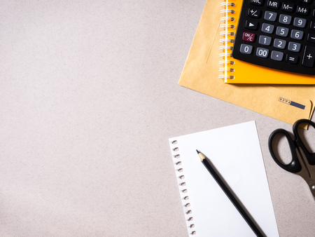 Notebook, pencil, envelope, calculator and scissors on the table. Top viewの写真素材