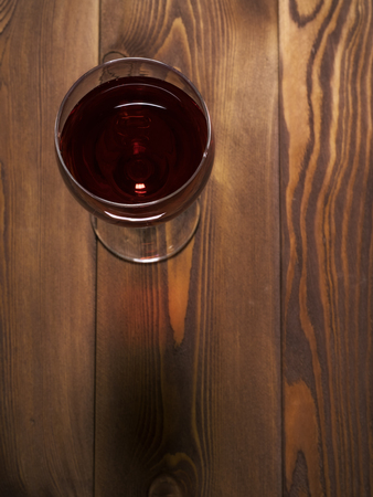 Glass of red wine on the wooden table. Top viewの写真素材