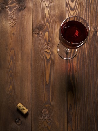 Glass of red wine on the wooden table. Top viewの写真素材