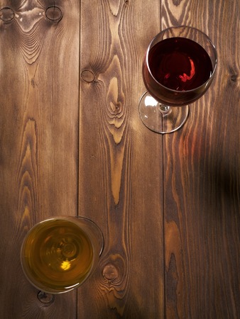 Glass of red and white wine on the wooden table. Top viewの写真素材