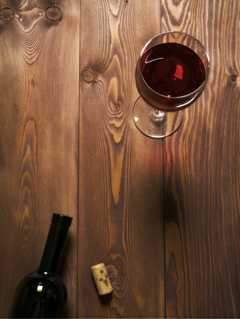Glass of red wine on the wooden table. Top viewの写真素材