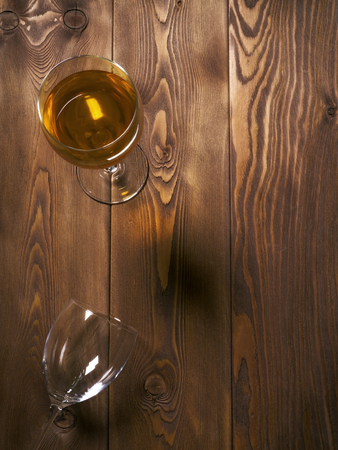 Glass of white wine on the wooden table. Top viewの写真素材