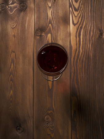 Glass of red wine on the wooden table. Top viewの写真素材