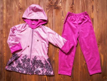 Top view of the little girl clothes on the wooden backgroundの写真素材