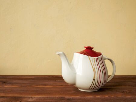 White teapot standing on the wooden tableの写真素材