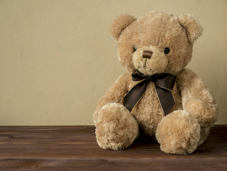 Toy bear sitting on the wooden floorの写真素材