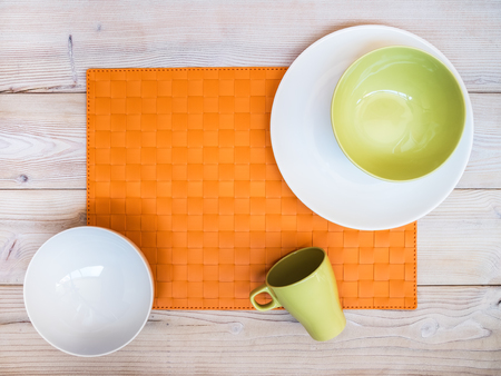 White and green plates and bowls on the table. View from aboveの写真素材