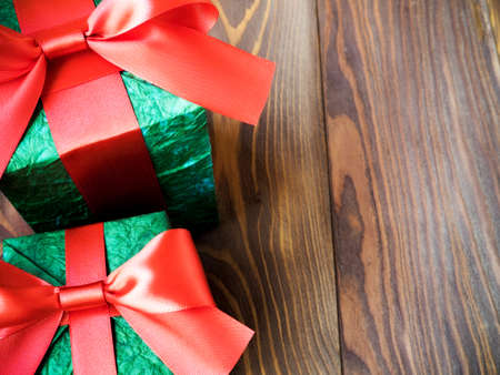 Gift boxes with red ribbons on wooden board. Holidays conceptの写真素材