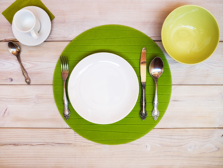 White and green plates and bowls on the table. View from aboveの写真素材