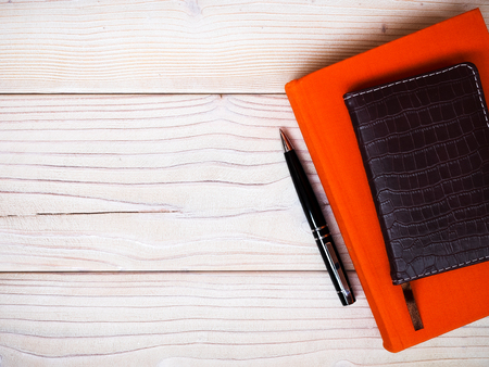 Composition of closed notebooks and ballpoint pen on wooden board. Education conceptの写真素材