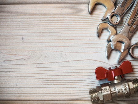 Several spanners on wooden board. Copy space. Plumbing conceptの写真素材
