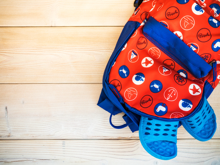 Children's backpack on the wooden board. Nautical theme. View from aboveの写真素材