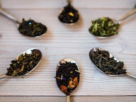 A few spoonfuls of tea on the wooden background. Shallow focusの写真素材