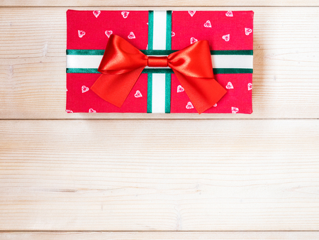Red gift box on wooden board. Copy space. Holidays conceptの写真素材