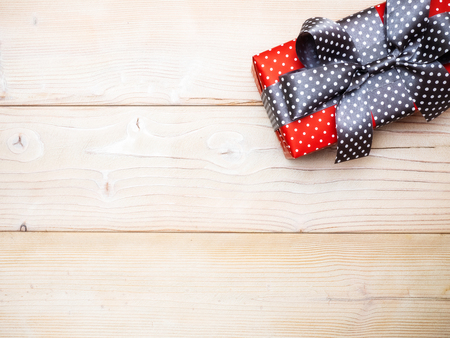 Red gift box on wooden board. Copy space. Holidays conceptの写真素材