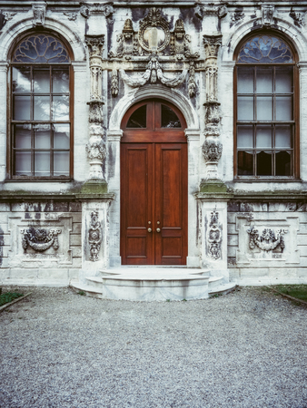Stone wall with the wooden door and windowsの写真素材