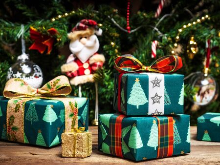 Gift boxes along with christmas toys on the wooden table. Side view. Holiday conceptの写真素材