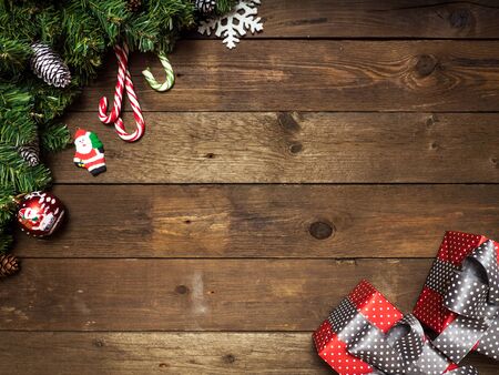 Christmas background. Fir branches with cones on the wooden background. Top view. Holiday conceptの写真素材