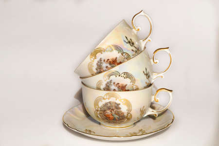 Antique porcelain set saucer and cup with a pattern and gildingの写真素材