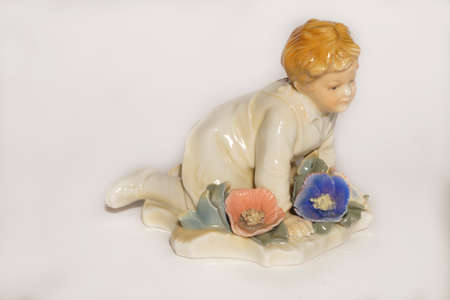 Vintage porcelain figurine of a boy on the meadowの写真素材