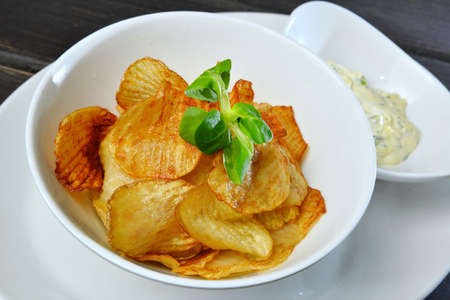 closeup of crunchy potato crisps in bowl