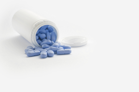 Blue Pills And Plastic Bottle Containerの写真素材