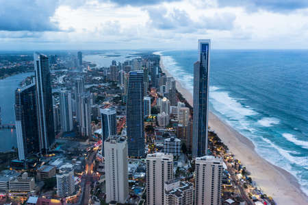 City by the beach at dusk, aerial, view from above. Surfers Paradise town, Gold Coast, Queensland, Australia at dusk, aerial viewの写真素材