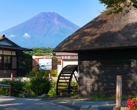 Oshino, Japan - September 2, 2016:Oshino Hakkai, Fuji Five Lakes. Japan countryside street with historic thatch roof farmhouses and Mt Fuji on the backgroundのeditorial素材