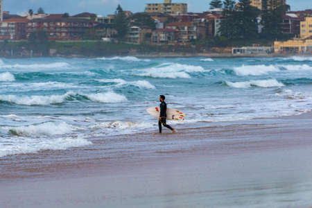 Sydney, Australia - August 7, 2016: Male surfer on Elouera beach on early morningのeditorial素材