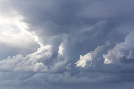 Stormy clouds with sunshine. Rainy weather backround, cloudscape