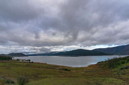 Australian rural landscape with lake on overcast dayの写真素材