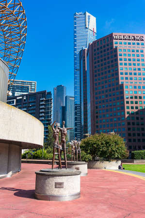 Melbourne, Australia - April 18, 2017: Sculptures of families near Arts Centre Melbourne with Eureka tower on the backgroundのeditorial素材