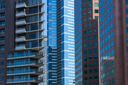Architecture background of modern buildings standing close to each other. Urban development and...