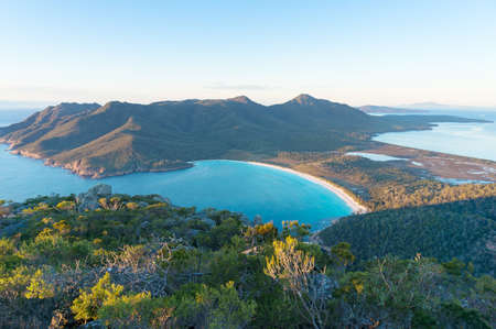 Aerial view of picturesque beach and mountains on sunny morning. Freycinet Park, Tasmania. Australiaの写真素材