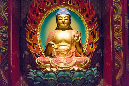 Singapore, Singapore - December 23, 2015: Meditating Buddha figurine at Buddha Tooth Relic Museum in Chinatownのeditorial素材