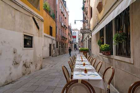 Venice, Italy - September 27, 2013: Tables set for al fresco dining restaurant in Veniceのeditorial素材